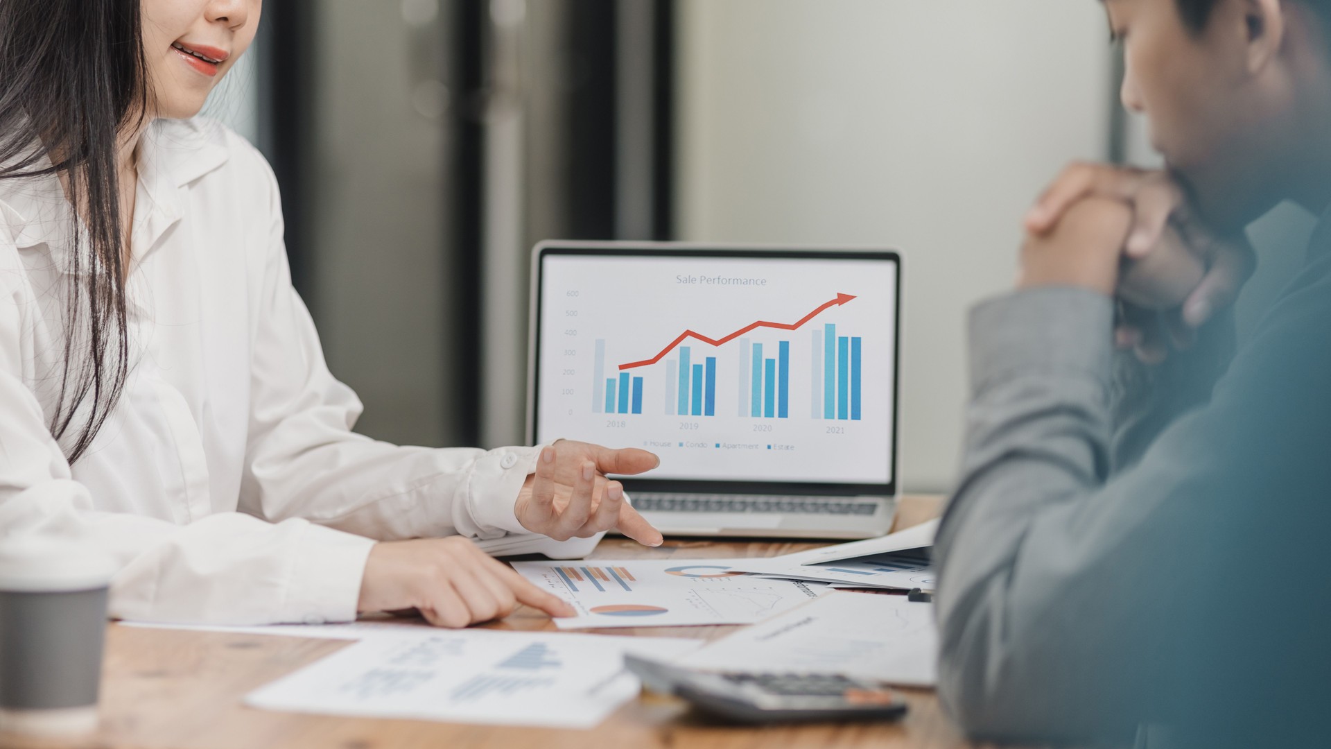 Business partners working with analysis report and advisor showing plan.